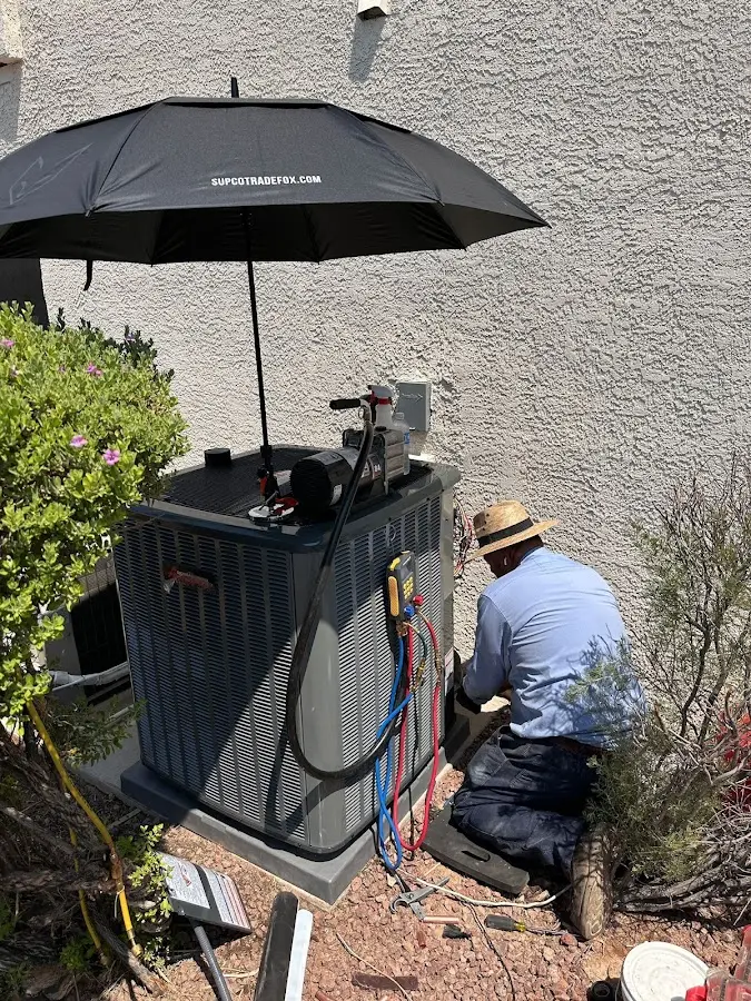 HVAC technician performing outdoor AC maintenance in Towson